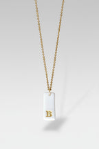 Gold Necklace with a white handmade porcelain pendant featuring a gold letter 'B'