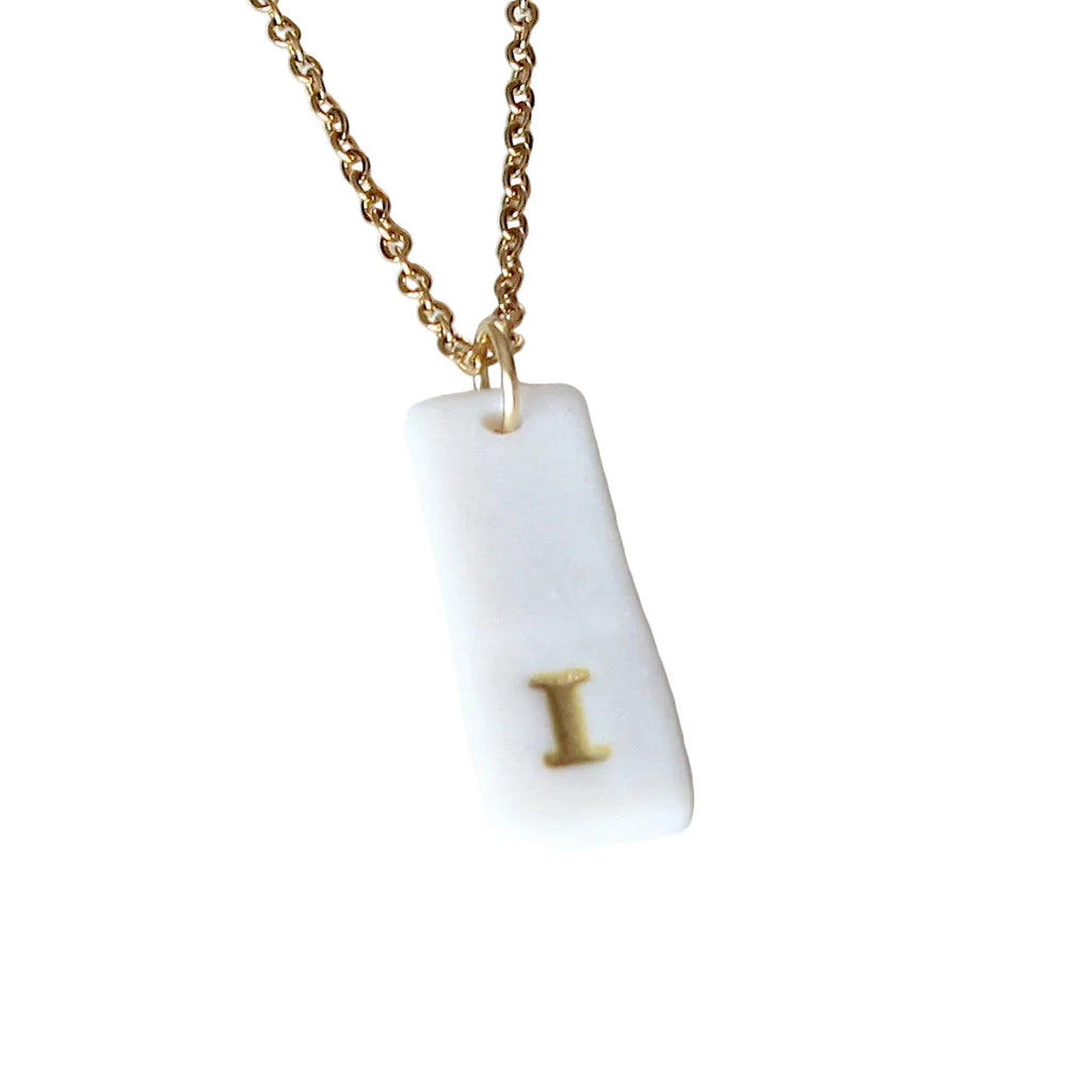 Gold Necklace with a white handmade porcelain pendant featuring a gold letter 'I'