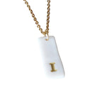 Gold Necklace with a white handmade porcelain pendant featuring a gold letter 'I'