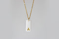 Gold Necklace with a white handmade porcelain pendant featuring a gold letter 'A'